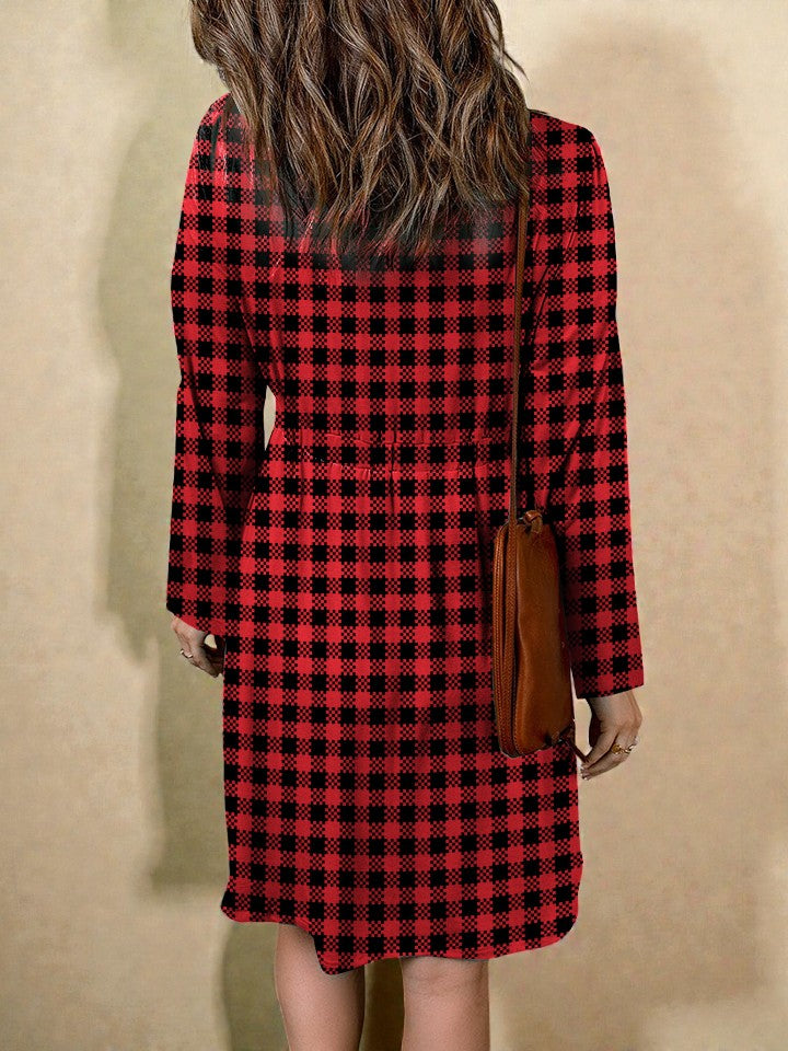Person wearing a red and black checkered dress against a beige background