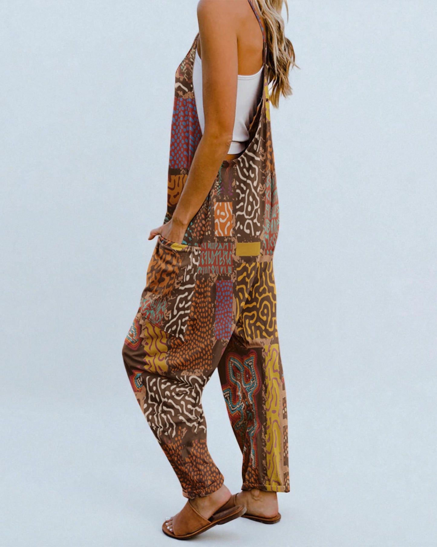 Person wearing a patterned harem pants with a plain background