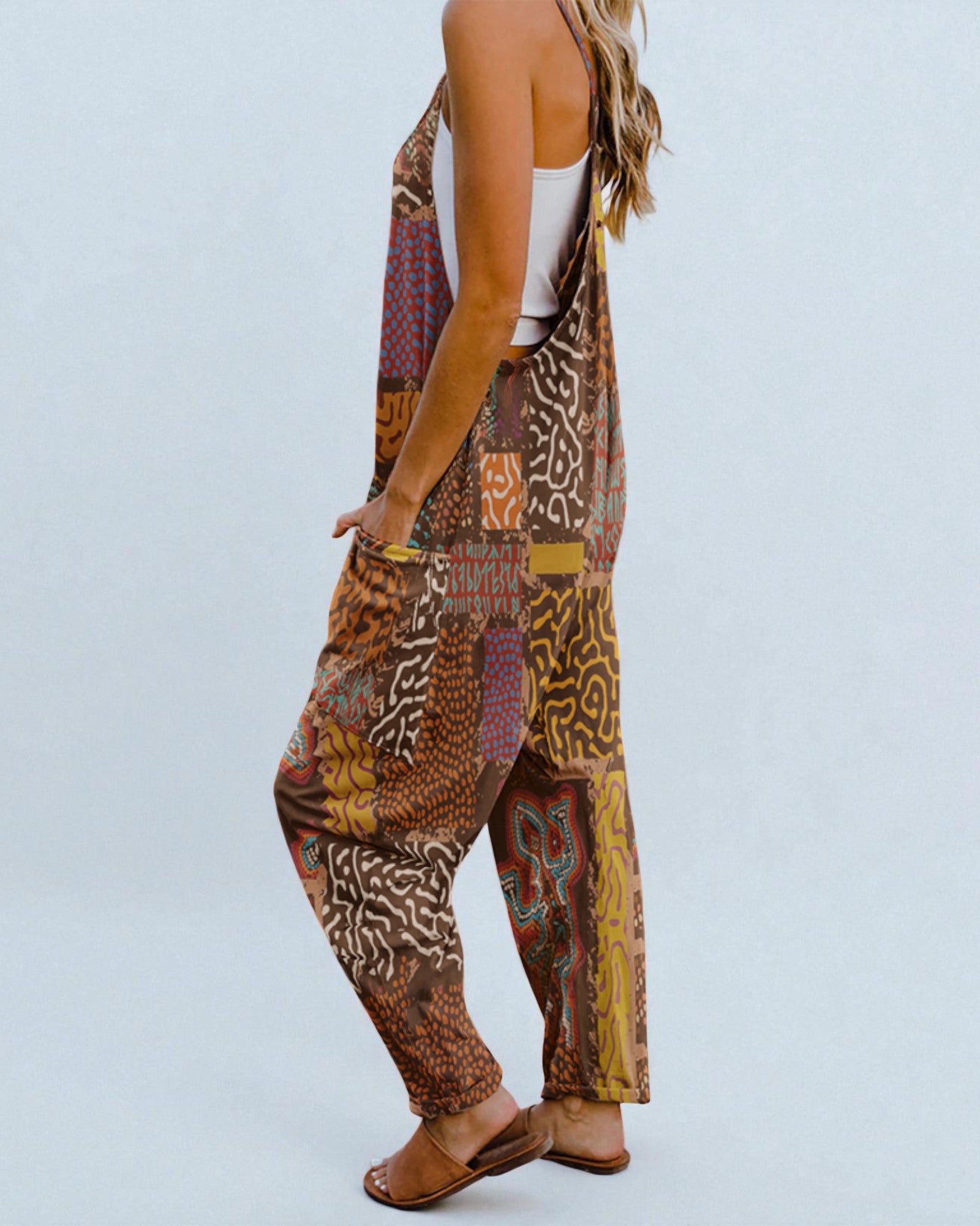 Person wearing a patterned harem pants with a plain background