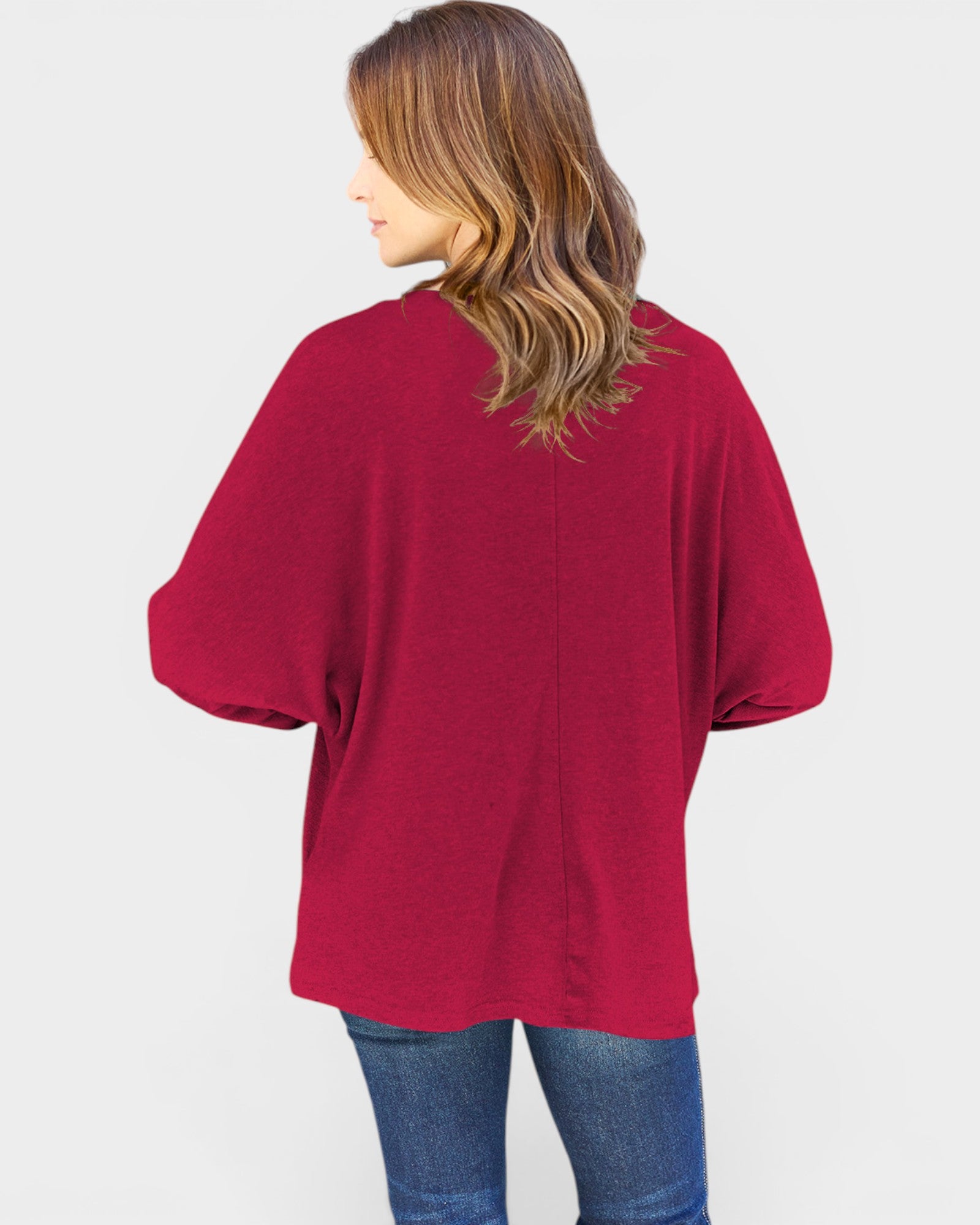 Person wearing a red oversized shirt on a white background