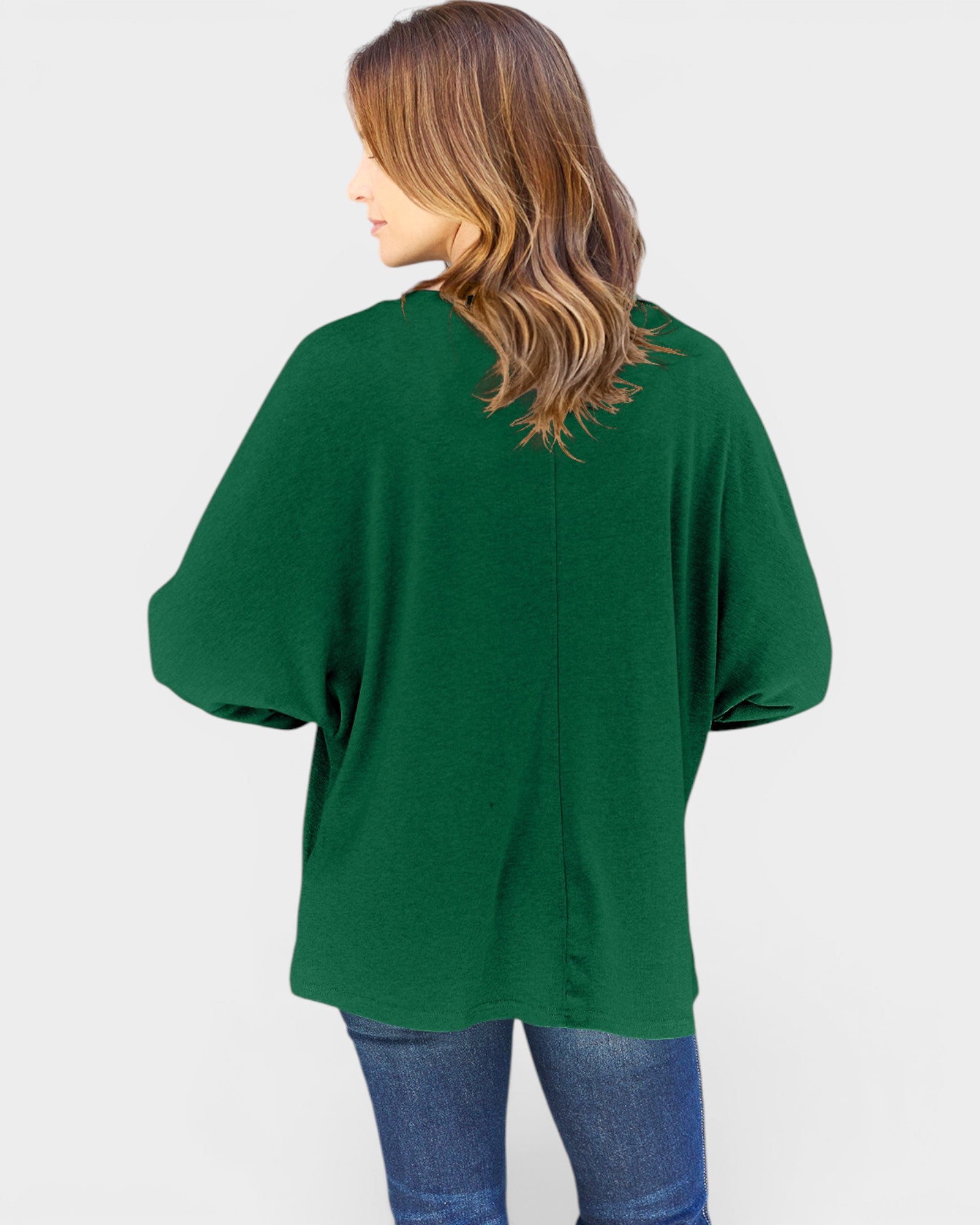 Person wearing a green sweater on a white background