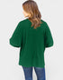 Person wearing a green sweater on a white background