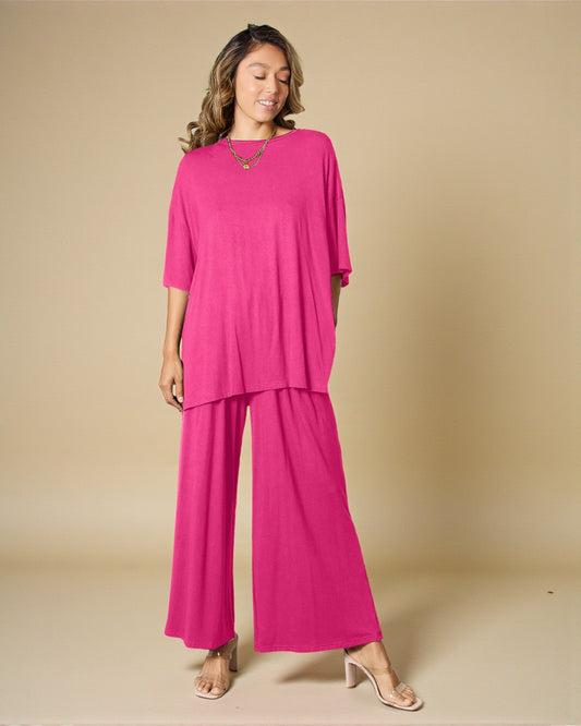 Woman wearing a bright pink outfit on a beige background