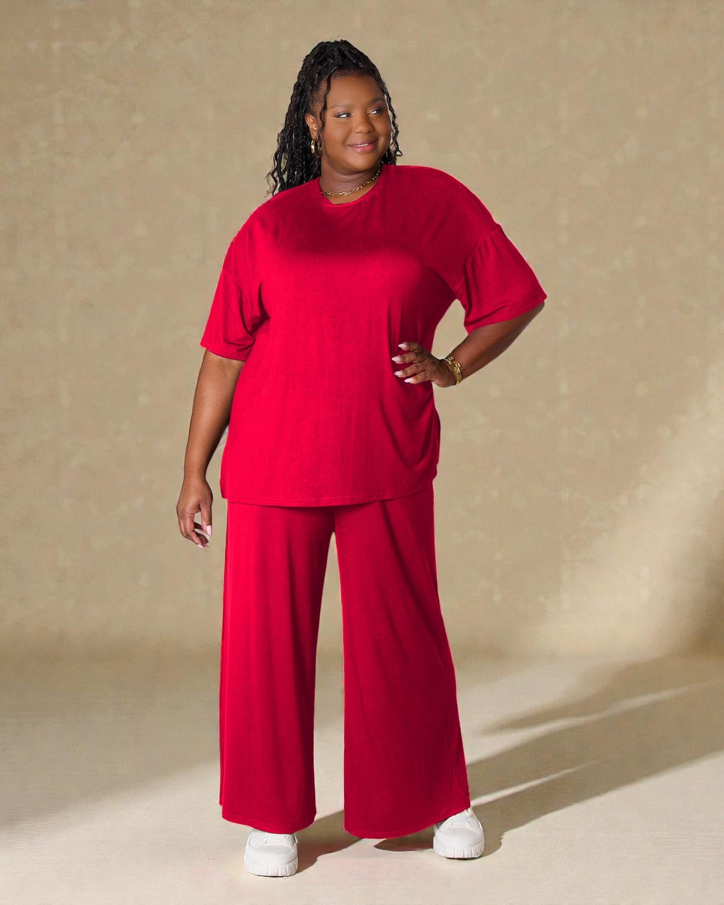 Person wearing a red outfit against a beige background