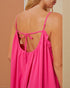 Pink strappy top worn by a person on a beige background