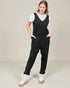 Woman wearing a black jumpsuit with a white background