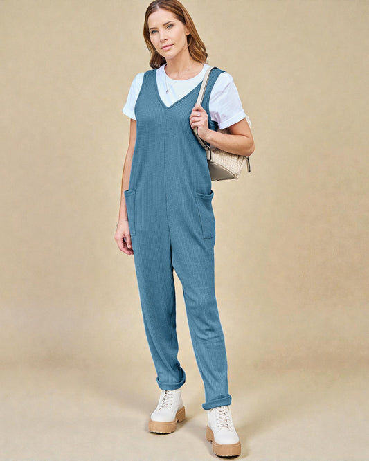 Woman wearing a blue denim overalls with a beige background