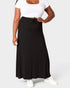 Person wearing a black skirt and white top on a plain background