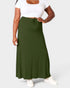 Person wearing a green skirt and white top on a plain background