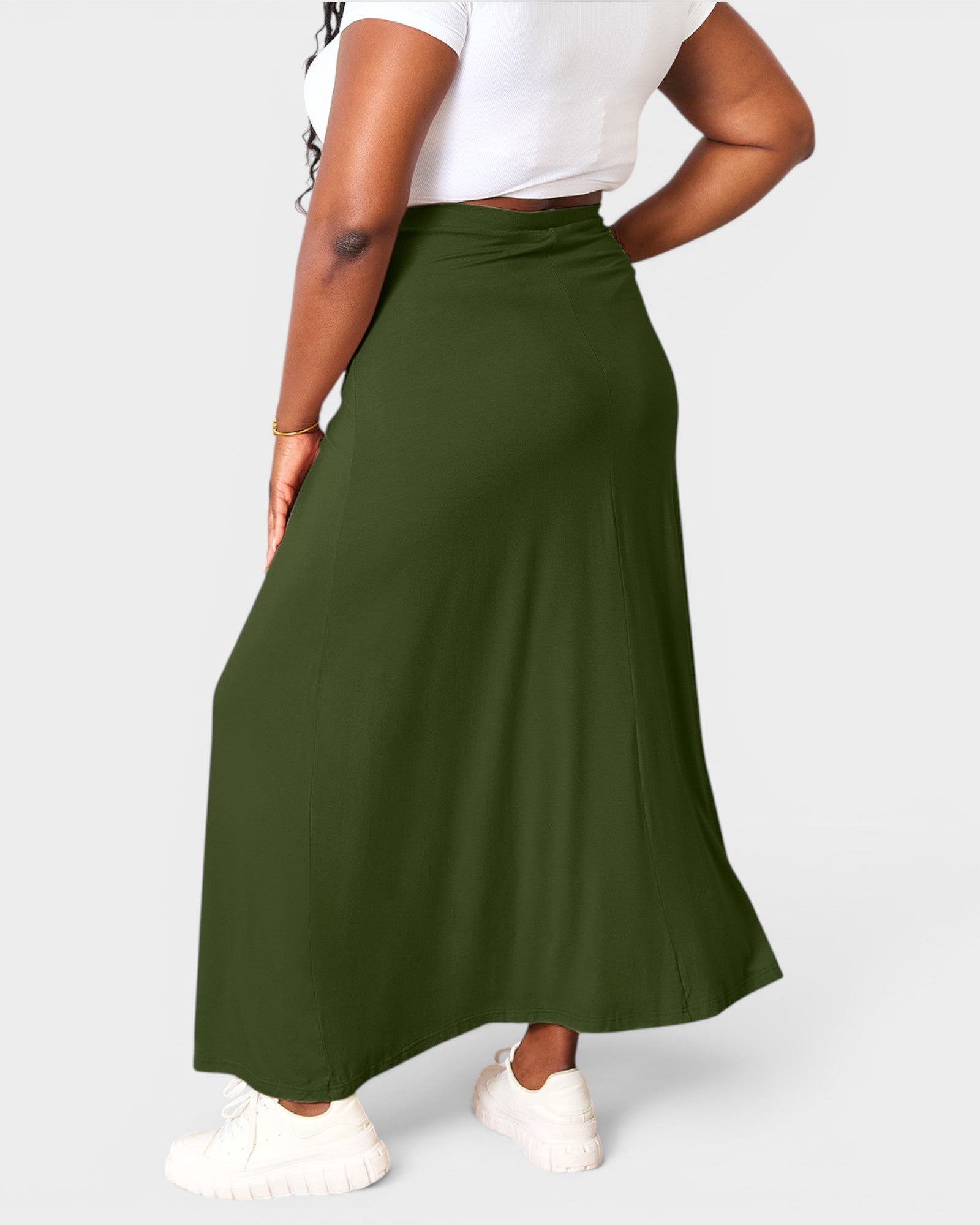 Person wearing a green skirt on a white background