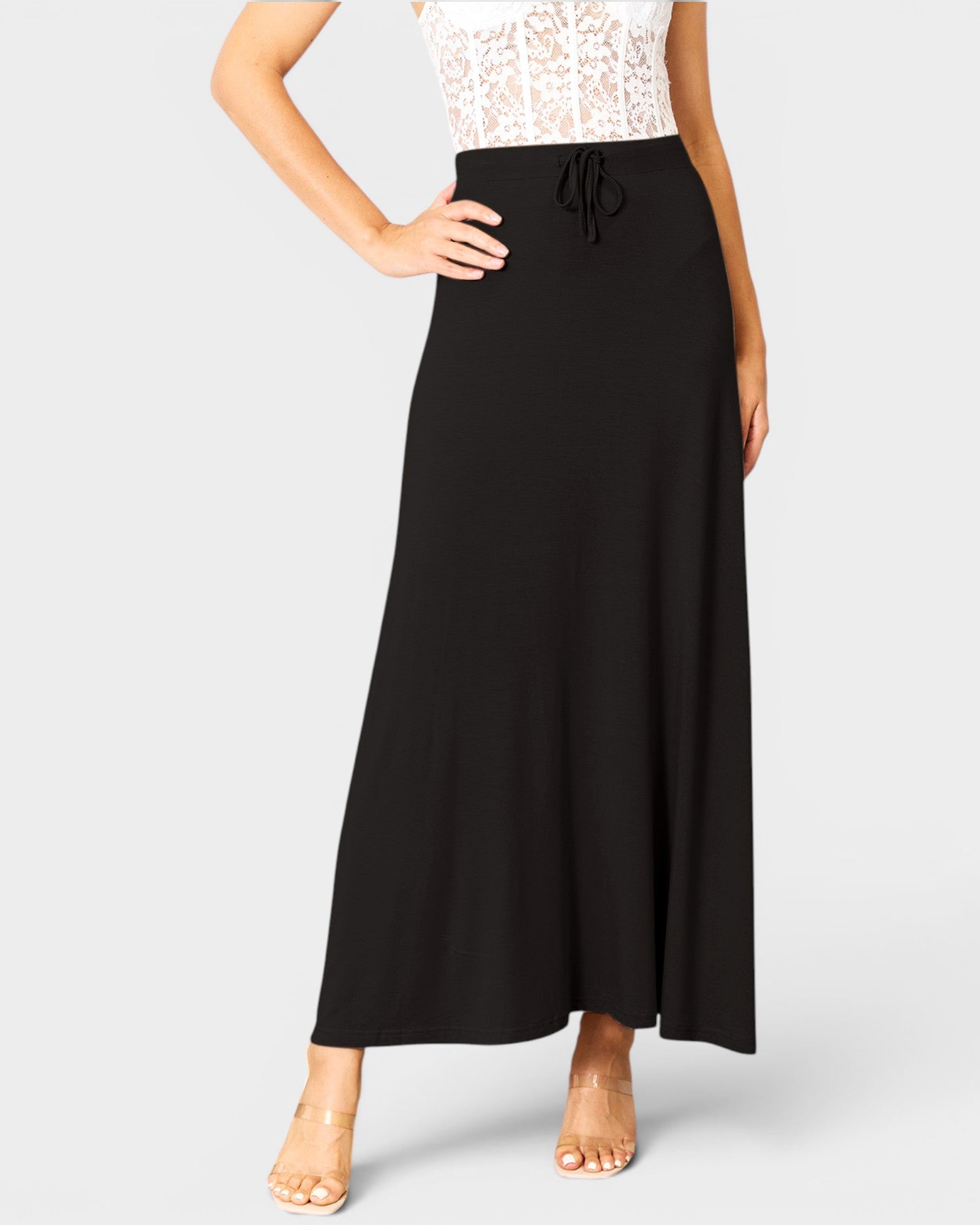 Black skirt worn by a person on a white background