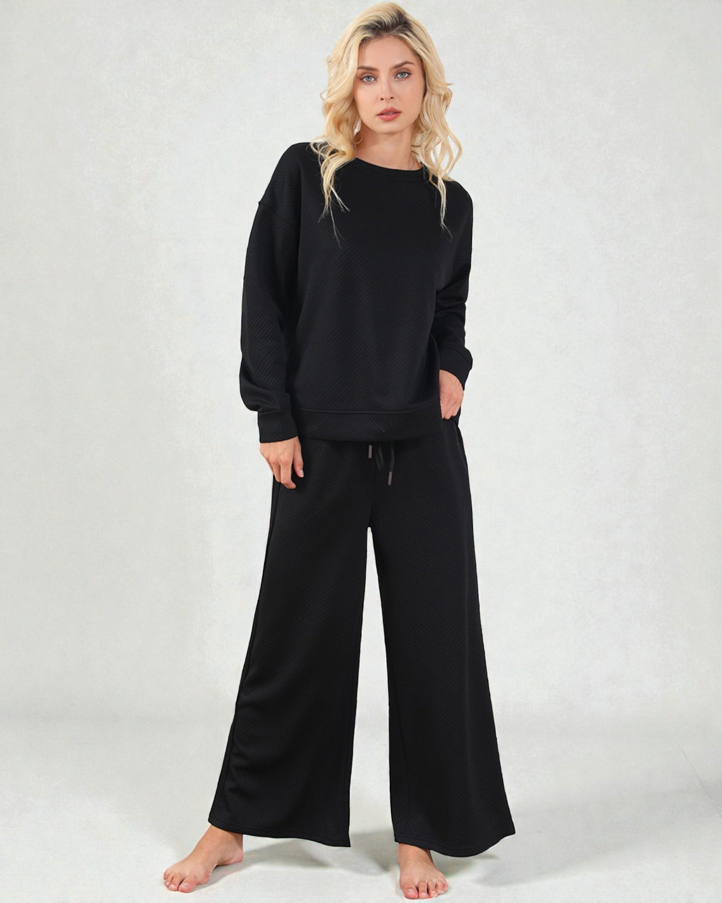 Woman wearing a black outfit on a white background