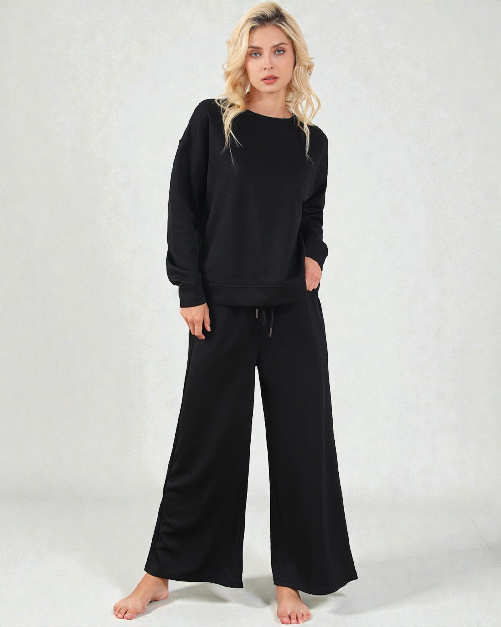 Woman wearing a black outfit on a white background