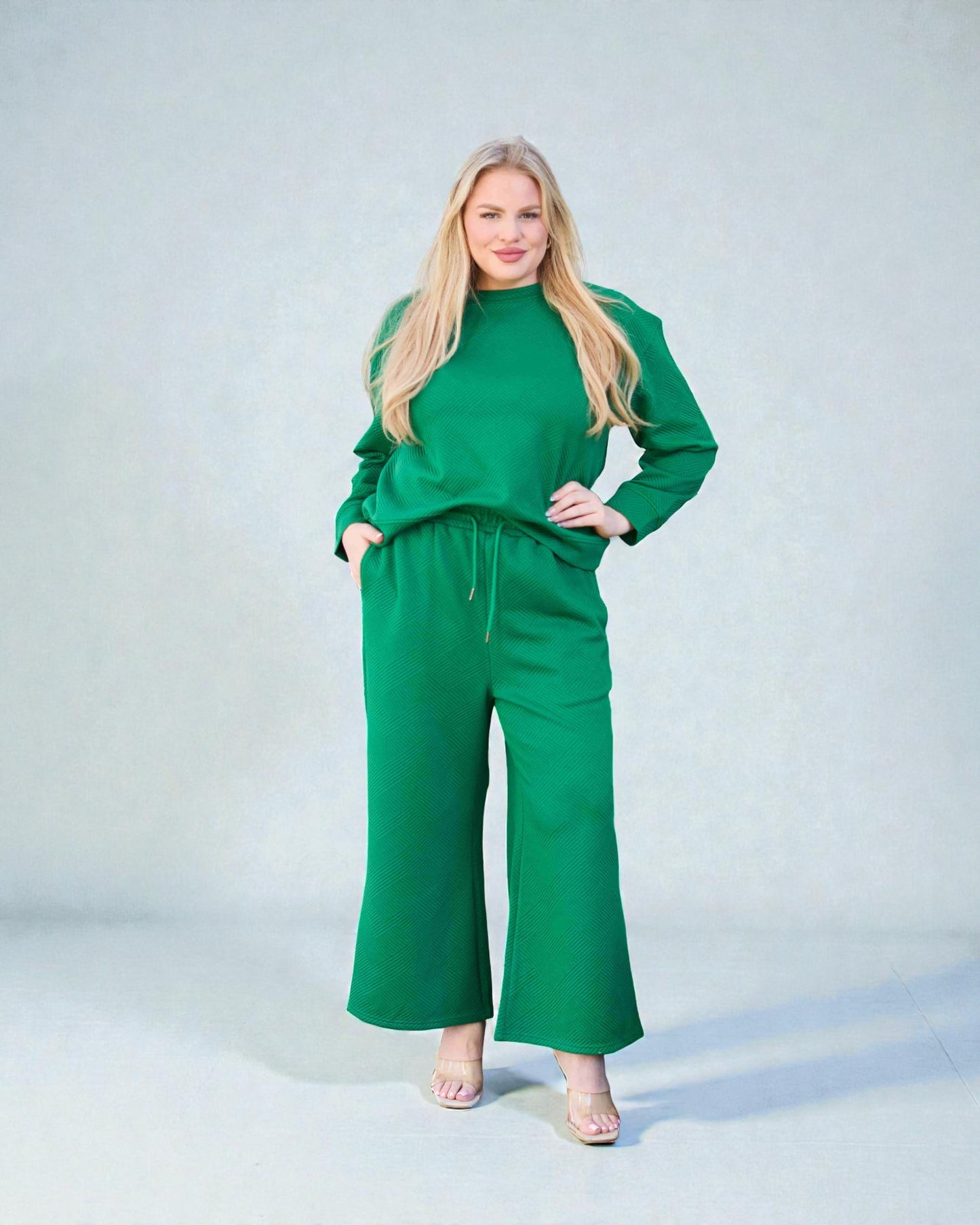 Woman wearing a green outfit against a light gray background