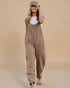 Woman wearing a beige jumpsuit against a beige background