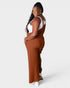 Woman wearing brown overalls on a white background