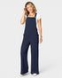 Woman wearing a navy blue jumpsuit on a white background