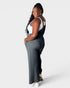 Woman wearing a dark gray jumpsuit on a white background