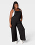 Woman wearing a black jumpsuit on a white background