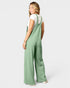 Woman wearing green checkered overalls on a white background