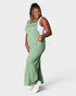 Woman wearing a green jumpsuit on a white background