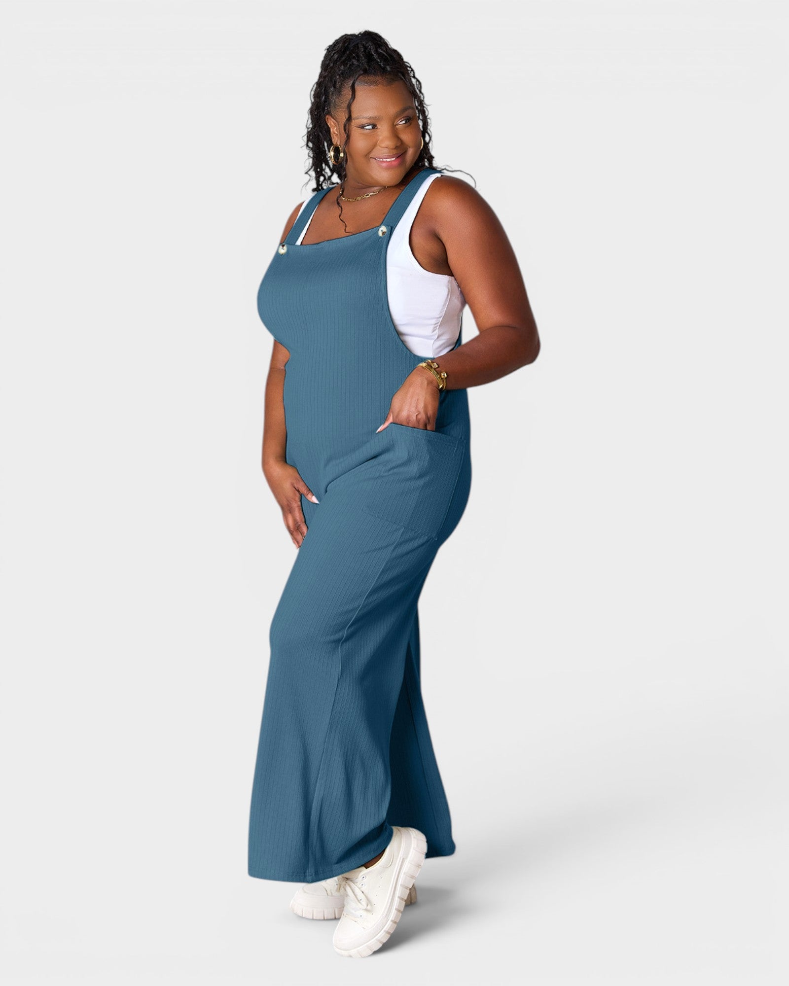Woman wearing a blue jumpsuit on a white background