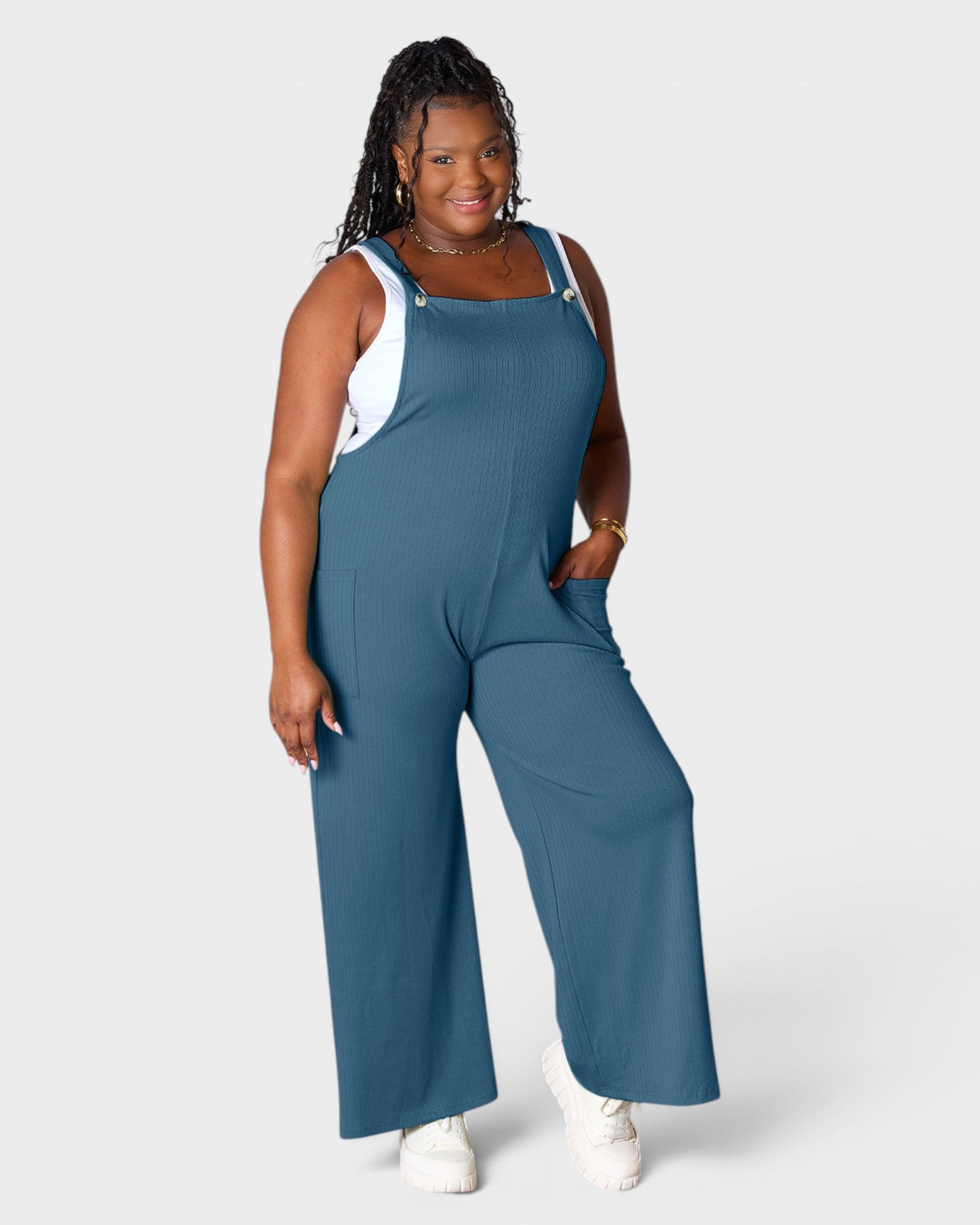 Woman wearing a blue jumpsuit on a white background