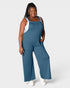 Woman wearing a blue jumpsuit on a white background
