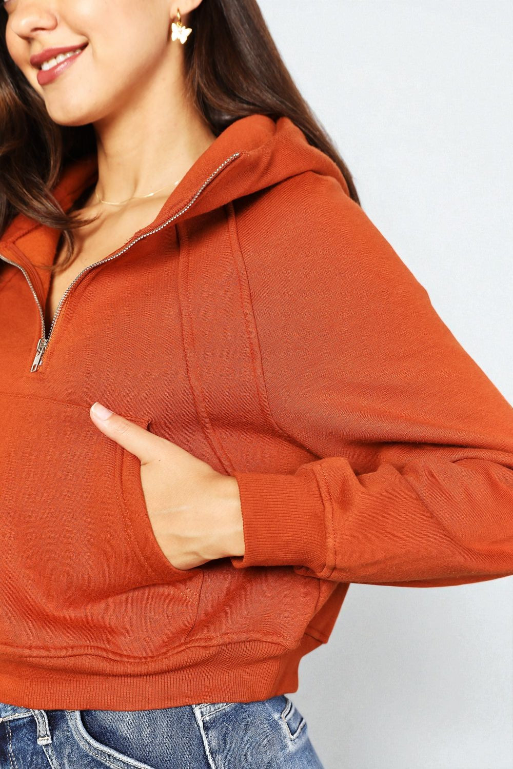 Person wearing a red hoodie with a plain background