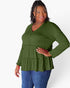 A woman modeling a long-sleeve olive green peplum top with a buttoned V-neckline, paired with blue jeans, against a plain white studio background.