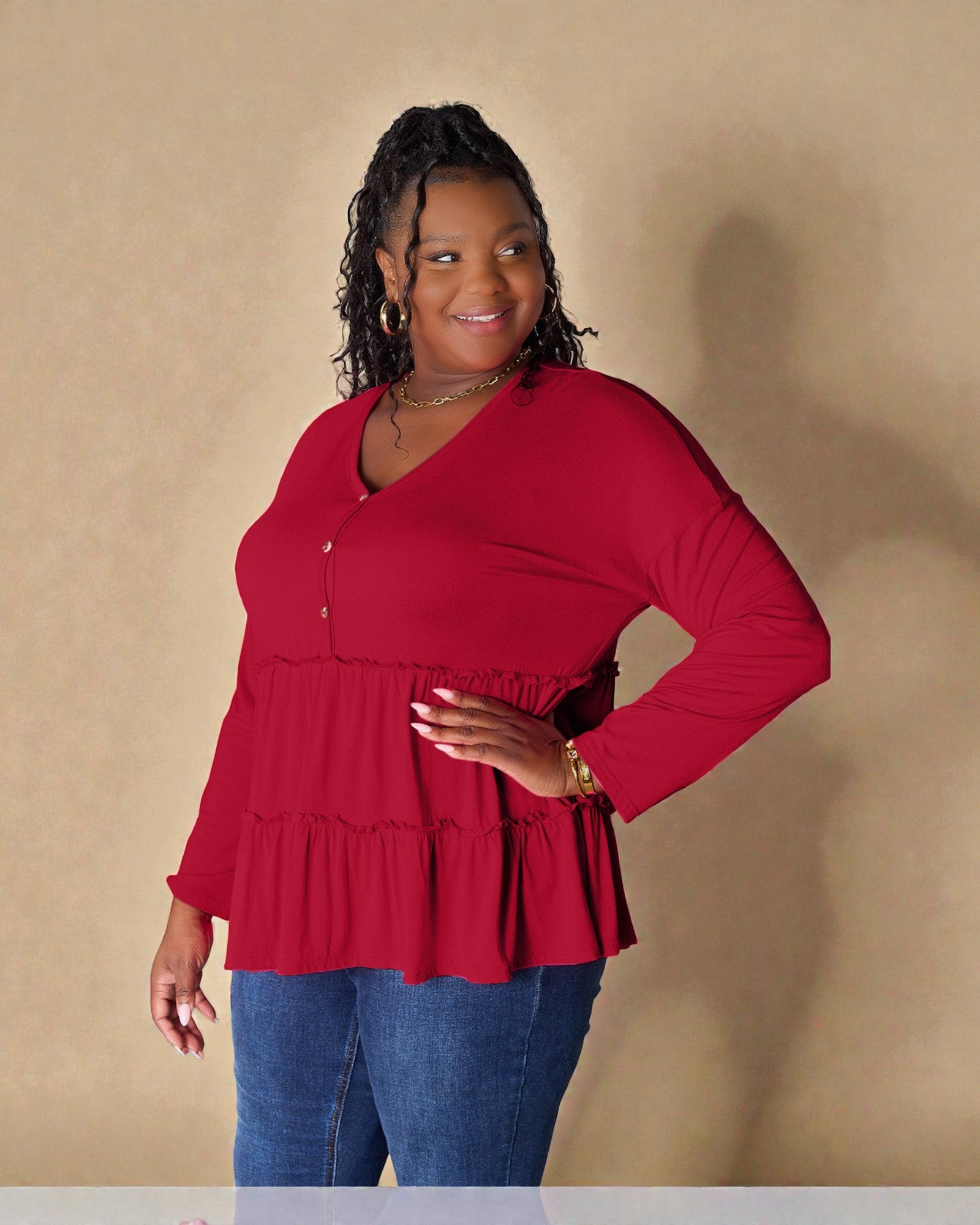 Woman wearing a red blouse with a plain background