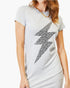 A woman wearing a light gray heathered t-shirt dress with a large black leopard-print lightning bolt graphic on the front, paired with a gold chain necklace.