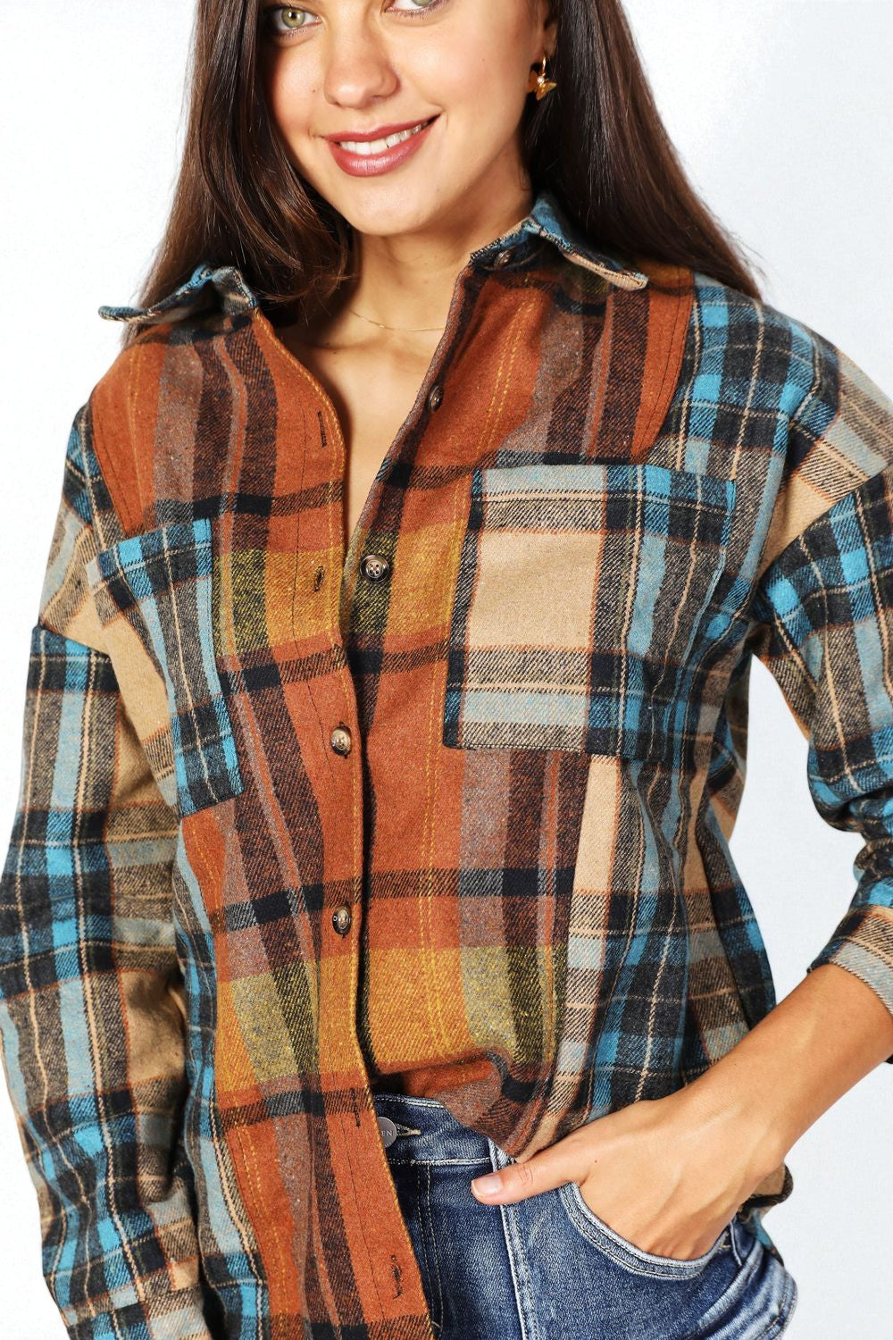 Woman wearing a plaid shirt with autumn colors on a white background