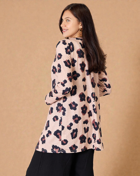 Woman wearing a floral blouse against a beige background