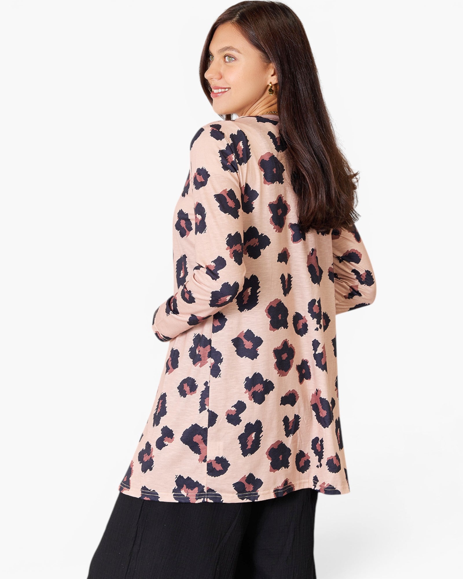 A woman shown from the back wearing a long-sleeve tunic top with a pink, black, and dark red leopard print pattern, paired with black pants, against a plain white background.
