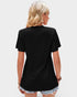 Person wearing a black t-shirt on a plain background