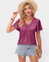 Woman wearing a purple t-shirt and denim shorts with a straw hat on a plain background