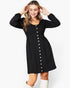 A woman modeling a black long-sleeve mini dress with a button-down front and gathered waist, paired with white boots against a plain white studio background.