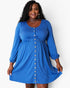 A woman modeling a bright blue long-sleeve maternity dress with a button-down front and gathered waist, set against a plain white studio background.
