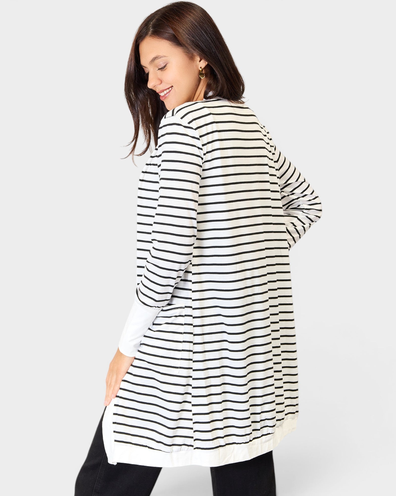 Woman wearing a black and white striped shirt on a plain background