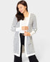Woman wearing a black and white striped cardigan on a white background