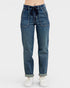 Blue jeans worn with white sneakers on a white background