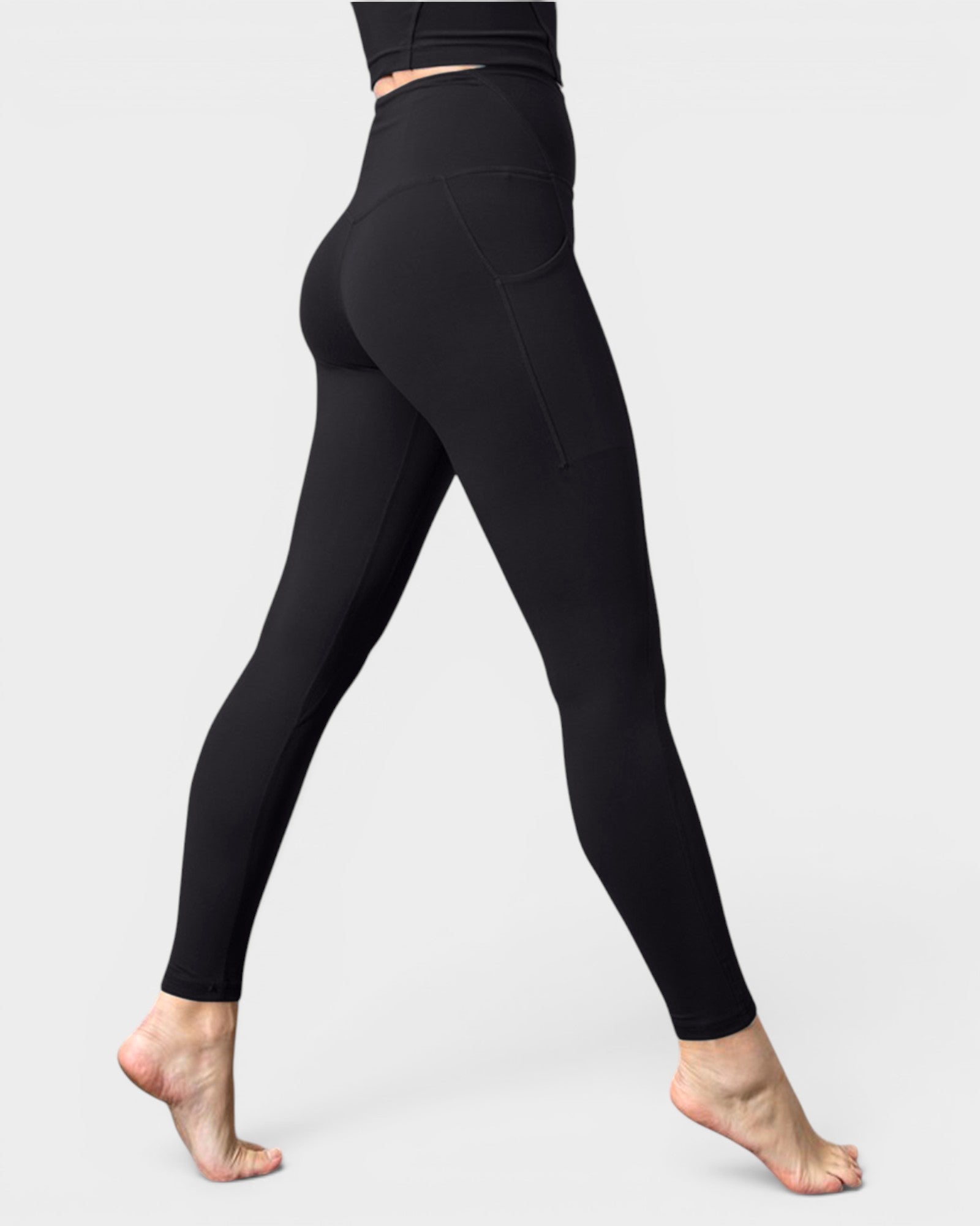 Black leggings worn by a person on a light gray background