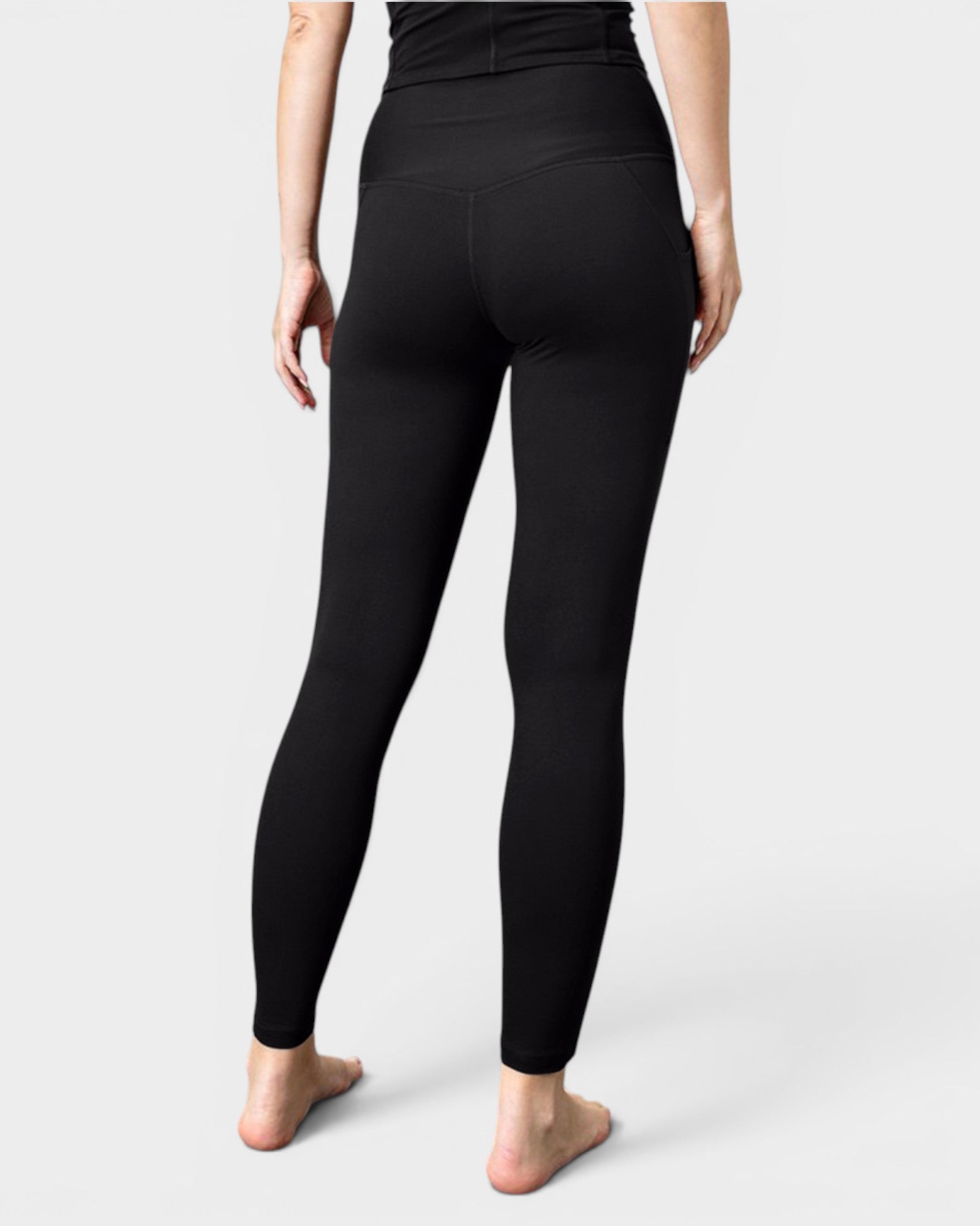 Person wearing black leggings on a white background