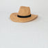 Woven straw hat with a black band on a white background