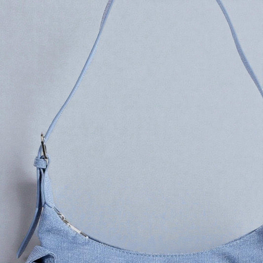 Light blue dress with thin straps on a neutral background