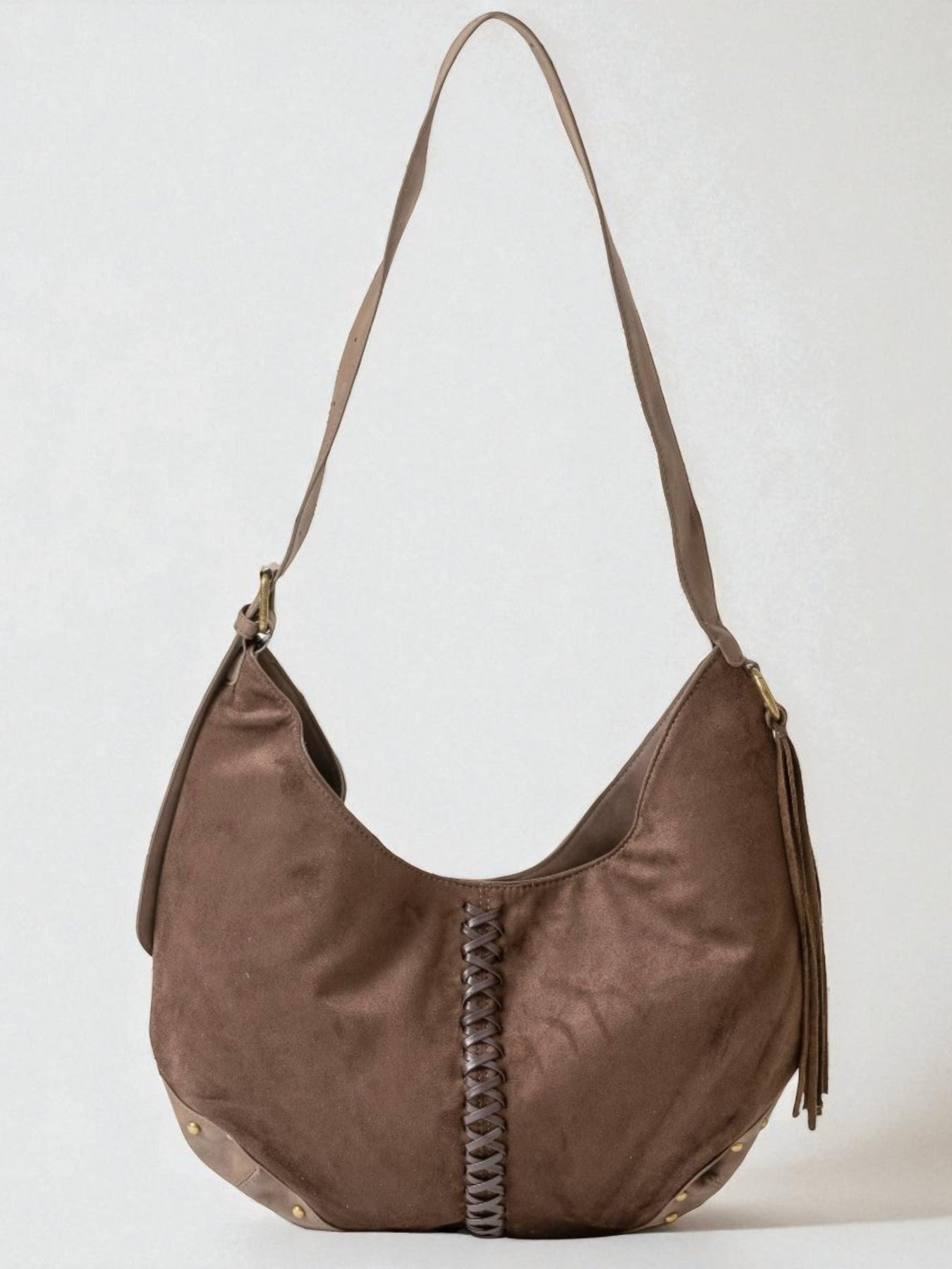 Brown leather handbag with braided detail on a white background