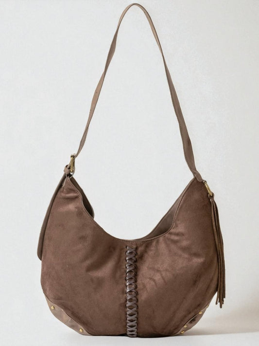 Brown leather handbag with braided detail on a white background