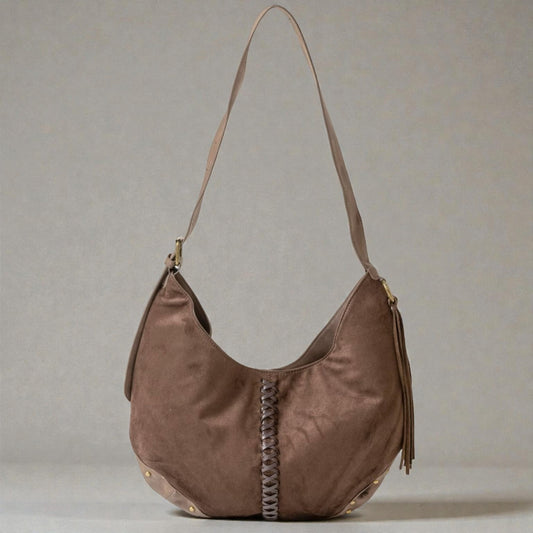 Brown handbag with braided detail on a gray background