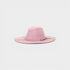 Pink suede hat with braided detail on a light gray background